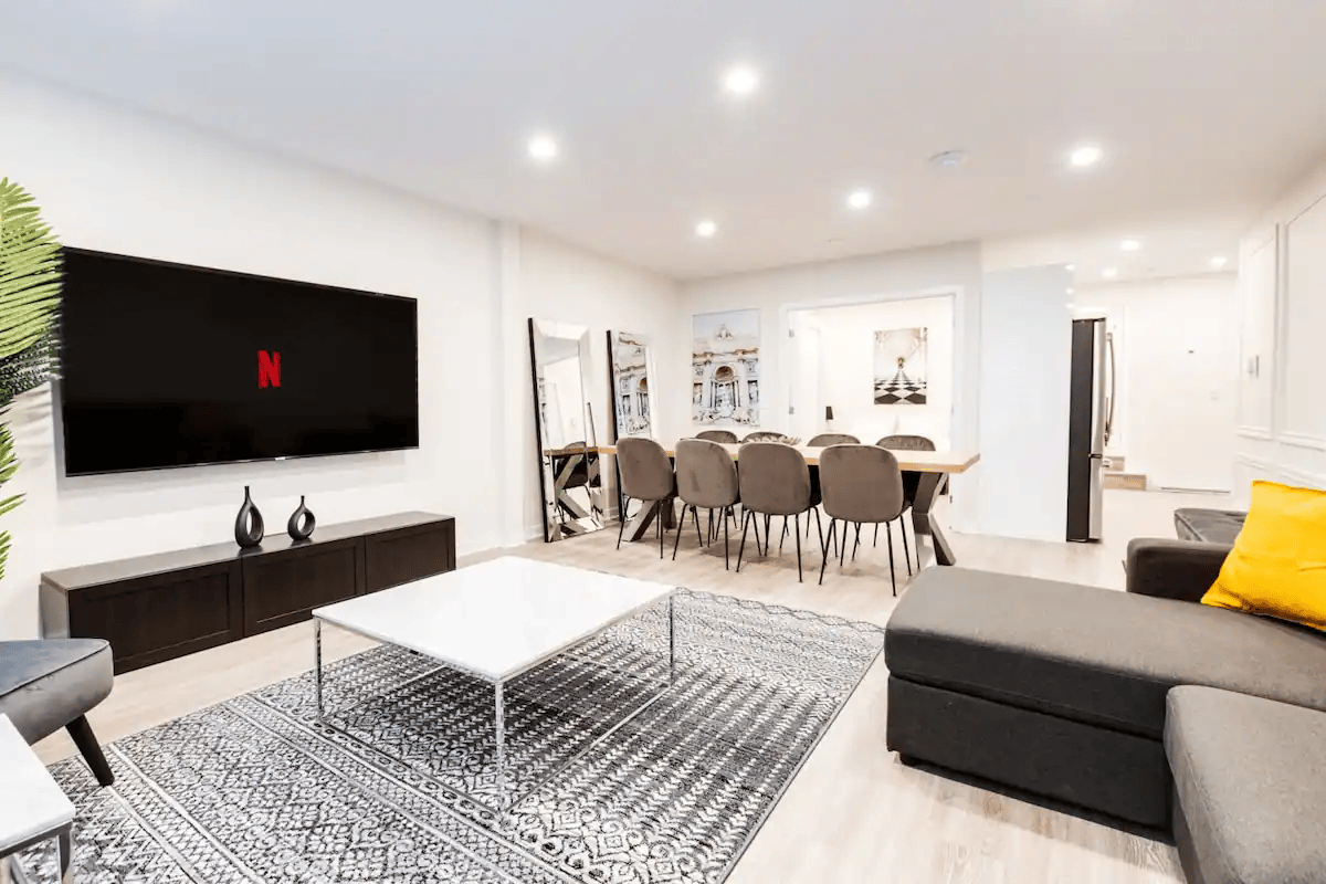 Modern living room with beige sectional sofa and patterned rug